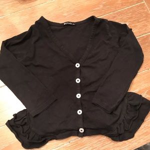 La made black cardigan with ruffle detail